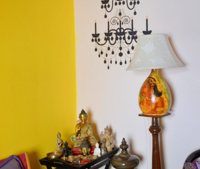 A Buddha corner with a chandelier decal