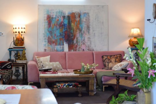 A pink velvet sectional in a modern Indian home. 